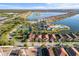 Overhead view showcases a community with lake views, tennis courts, and a pool at 108 Maraviya Blvd, Nokomis, FL 34275