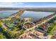 Stunning aerial view of a lakeside community with access to a pool, tennis court and other amenities at 108 Maraviya Blvd, Nokomis, FL 34275