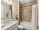 Bright bathroom featuring tiled walls, a shower-tub combo, a sleek vanity and a large mirror at 108 Maraviya Blvd, Nokomis, FL 34275