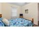 Bright bedroom featuring tropical bedding, a quaint side table, and comfortable space at 108 Maraviya Blvd, Nokomis, FL 34275