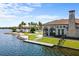 Lakeside clubhouse featuring manicured lawn, private dock, sandy beach and community pool at 108 Maraviya Blvd, Nokomis, FL 34275
