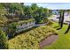 Beautiful entrance to Toscana Isles, featuring lush landscaping and elegant stone signage at 108 Maraviya Blvd, Nokomis, FL 34275
