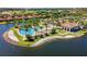 Aerial view of a resort-style pool, clubhouse and tennis courts in a desirable community at 108 Maraviya Blvd, Nokomis, FL 34275