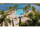 Resort-style pool with palm trees, beach area and lounge chairs overlooking a lake at 108 Maraviya Blvd, Nokomis, FL 34275
