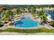 Expansive zero entry community pool with palm trees, beach and clubhouse at 108 Maraviya Blvd, Nokomis, FL 34275