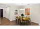 Dining room with hardwood floors and view into a hallway and kitchen at 108 Maraviya Blvd, Nokomis, FL 34275