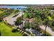 Scenic community entrance with lush landscaping, a guardhouse, and palm-lined streets at 108 Maraviya Blvd, Nokomis, FL 34275