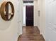 Hallway with hardwood floors and a decorative shelf near the front door at 108 Maraviya Blvd, Nokomis, FL 34275