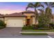 Charming single-story home featuring a tile roof, a two-car garage, and a well-manicured front yard at 108 Maraviya Blvd, Nokomis, FL 34275