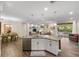 The kitchen overlooks a dining area and a living area with access to a backyard pool at 108 Maraviya Blvd, Nokomis, FL 34275