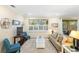Well-lit living room with neutral decor, plantation shutters, and hardwood flooring at 108 Maraviya Blvd, Nokomis, FL 34275