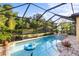 Beautiful pool area with lush landscaping and spa creating a relaxing outdoor retreat at 108 Maraviya Blvd, Nokomis, FL 34275