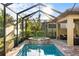Resort-style pool with a spa and lush greenery provides a tranquil and private backyard retreat at 108 Maraviya Blvd, Nokomis, FL 34275