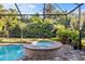 Beautiful screened-in pool and spa area surrounded by lush tropical landscaping offering a private backyard oasis at 108 Maraviya Blvd, Nokomis, FL 34275