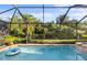 Refreshing screened-in pool surrounded by lush landscaping providing privacy and a tropical oasis at 108 Maraviya Blvd, Nokomis, FL 34275