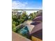 Aerial view of screened-in pool with lake view, surrounded by lush landscaping and neighboring houses at 108 Maraviya Blvd, Nokomis, FL 34275
