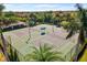 Aerial shot of community tennis courts surrounded by palm trees and lush greenery at 108 Maraviya Blvd, Nokomis, FL 34275