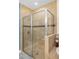 Walk-in shower featuring tiled walls, a glass door, and a built-in seat at 108 Maraviya Blvd, Nokomis, FL 34275
