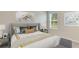 Relaxing bedroom showcases a beautifully decorated bed, soft lighting, and stylish decor at 10853 Gentle Current Way, Parrish, FL 34219