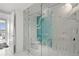 Beautiful bathroom featuring a walk-in shower with glass doors and ocean-themed decor at 1155 N Gulfstream Ave # 708, Sarasota, FL 34236