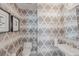 Powder room featuring patterned wallpaper, modern fixtures, and stylish decor adding a touch of elegance at 1155 N Gulfstream Ave # 708, Sarasota, FL 34236