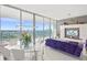 Bright living and dining area with glass table, sofa, and a view of the water at 1155 N Gulfstream Ave # 708, Sarasota, FL 34236