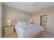 Bright bedroom features neutral walls, ceiling fan, and ensuite bath access at 12410 Osorio Ct # 204, Sarasota, FL 34238