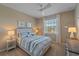 Bedroom with a large window providing ample natural light and ceiling fan at 12410 Osorio Ct # 204, Sarasota, FL 34238