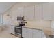 Bright kitchen featuring stainless steel appliances, granite countertops, and white cabinetry at 12410 Osorio Ct # 204, Sarasota, FL 34238