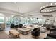 Bright lounge area with ample seating, large windows, and modern chandeliers at 12410 Osorio Ct # 204, Sarasota, FL 34238