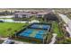 Aerial view of community pickleball courts with palm tree landscaping at 12410 Osorio Ct # 204, Sarasota, FL 34238