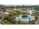 Aerial shot of community pool with island feature, cabanas and water park at 12410 Osorio Ct # 204, Sarasota, FL 34238