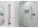 Sleek bathroom with marble tile shower, glass enclosure, and designer shower fixtures at 128 Da Vinci Dr, Nokomis, FL 34275