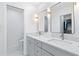 Elegant bathroom with double sinks, modern fixtures, and well lit vanity mirrors at 128 Da Vinci Dr, Nokomis, FL 34275