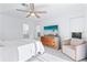Bright bedroom featuring a ceiling fan, TV atop a dresser, and a cozy armchair at 128 Da Vinci Dr, Nokomis, FL 34275