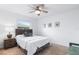 Cozy bedroom with a queen-sized bed, carpet floors, and a window at 128 Da Vinci Dr, Nokomis, FL 34275