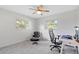 Well-lit bedroom with large windows, a sleek desk, and comfortable seating arrangement at 128 Da Vinci Dr, Nokomis, FL 34275