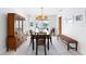 Formal dining room with pool view, modern light fixture, and classic furniture at 128 Da Vinci Dr, Nokomis, FL 34275