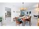 Elegant dining room featuring a wooden table, stylish chandelier, and seamless transition to living area at 128 Da Vinci Dr, Nokomis, FL 34275