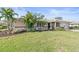 Beautiful single-story home with lush landscaping, mature palm trees, and well-manicured green lawn at 128 Da Vinci Dr, Nokomis, FL 34275