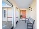Inviting front porch with decorative bench, stylish light fixture, and view of the front yard at 128 Da Vinci Dr, Nokomis, FL 34275
