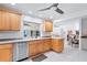Charming kitchen with wooden cabinets, stainless steel appliances, and a view into the living area at 128 Da Vinci Dr, Nokomis, FL 34275