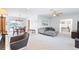 Spacious living room featuring modern furniture, lots of natural light, and an open floor plan at 128 Da Vinci Dr, Nokomis, FL 34275