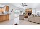 Bright living room with stone fireplace, comfortable seating, and open layout to the kitchen at 128 Da Vinci Dr, Nokomis, FL 34275