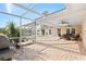 Spacious screened-in patio with seating, grill, and view of the inviting pool at 128 Da Vinci Dr, Nokomis, FL 34275