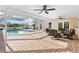 Relaxing screened-in patio with ceiling fans, outdoor seating, and a sparkling pool for luxurious outdoor living at 128 Da Vinci Dr, Nokomis, FL 34275