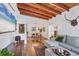 Open concept living room and dining room featuring exposed wood beams and lots of sunlight at 1301 6Th W St, Palmetto, FL 34221