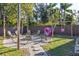 Inviting backyard fire pit area with chairs for relaxation and a swing set at 1305 20Th W St, Bradenton, FL 34205