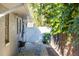 Side yard view of a brick home with a walkway leading to a white gate at 1305 20Th W St, Bradenton, FL 34205