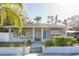 Charming home featuring a blue front door, a cozy front porch, and a freshly landscaped yard at 1305 20Th W St, Bradenton, FL 34205